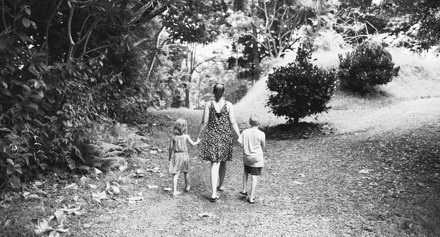 Family holding hands walking on a trail