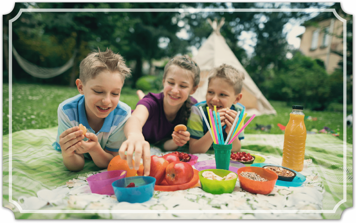Kids eating lunch outside at a picnic