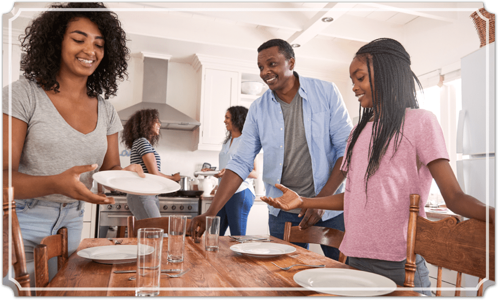 a family setting the table for a meal together
