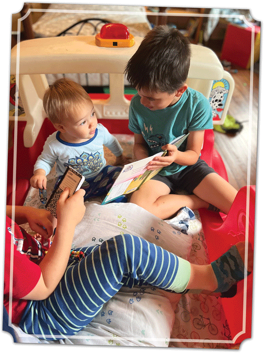 three kids reading a book