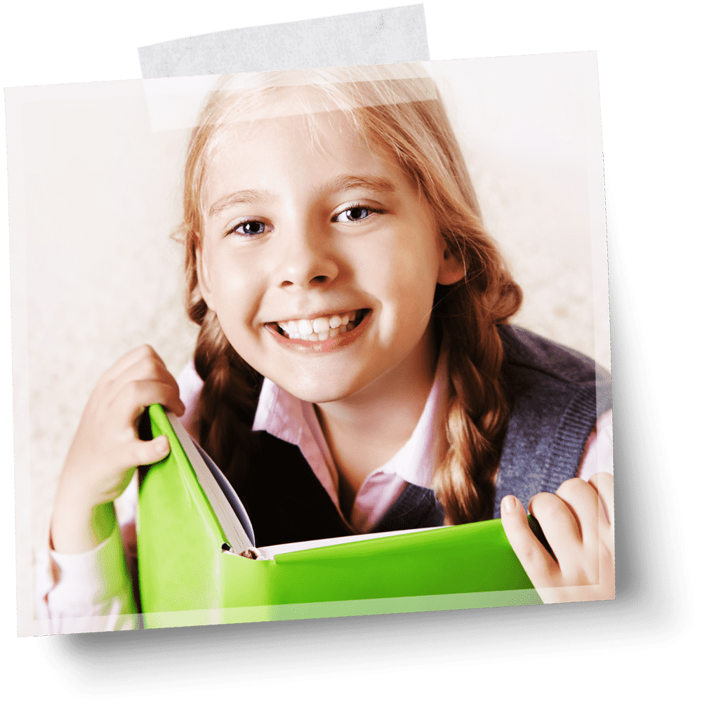 a smiling young girl with her hair in two braids holds a green binder full of paper