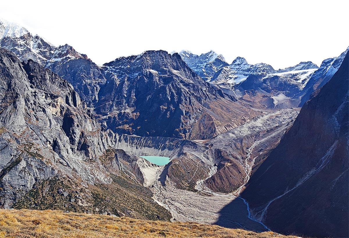 wide view of a quarry fenced by snow capped peaks