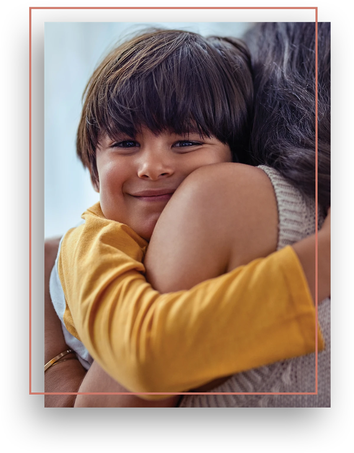 young boy hugging his mother