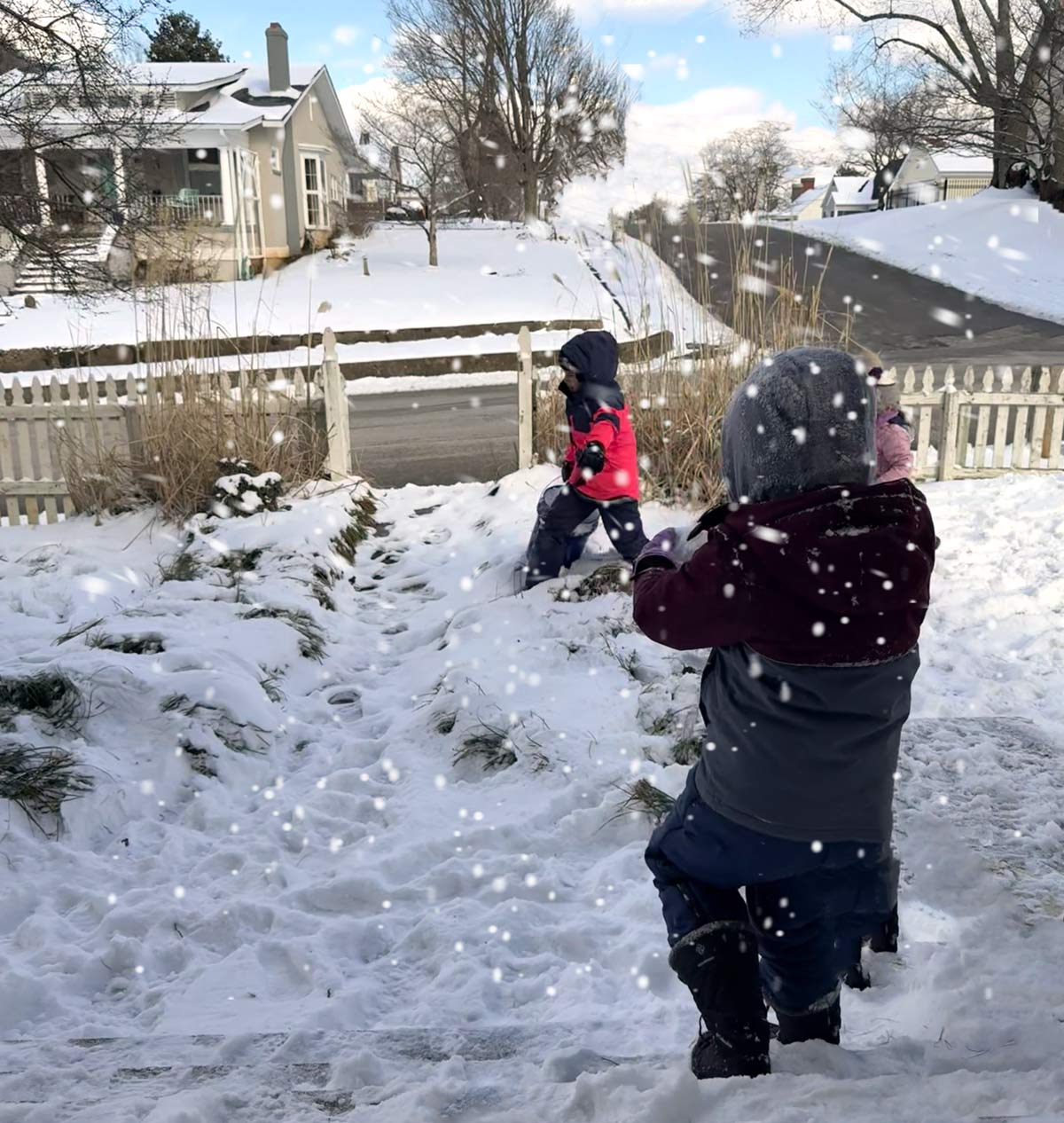 two children playing in snow