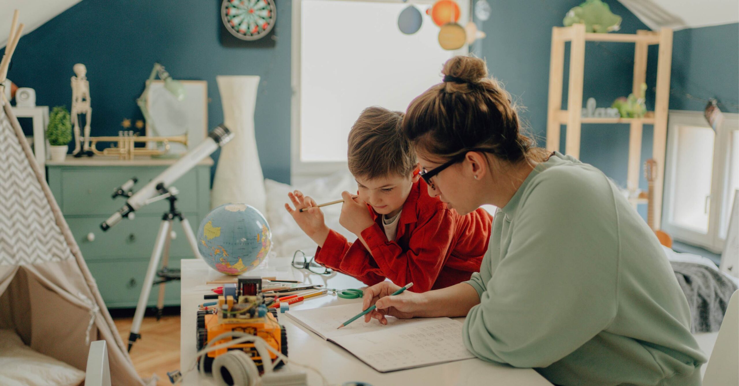 mom with child at desk working on activity book